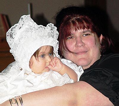 Helena hugs her daughter MaryAnna during the baby’ christening in early March.