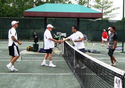 The father-son team of Paul and David Kramer, left, shakes hands with their opponents, A.J. Almanzor and Romeo Laurente, after a B-Division match during the 22nd annual Volley For SERV Tennis Tournament fundraiser at Cherry Valley Country Club.