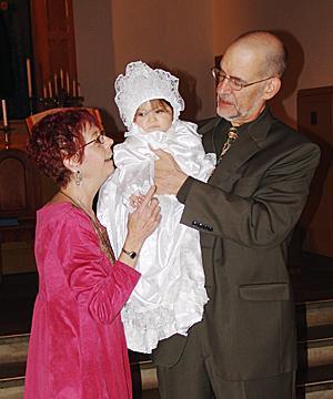 Helena’s foster parents, Pat and Bob, hold MaryAnna during the baby’s christening in March at the United Presbyterian Church in Plainfield.