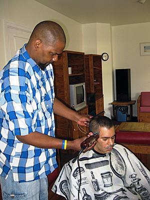 Using tools he bought with funds from the SERV Foundation, Wayne gives a haircut to fellow SERV consumer, Carlos, at the Serenity House in Mercer County.